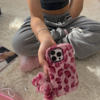 KASED Fuzzy Flirt iPhone case – pink furry leopard plush, shown on iPhone