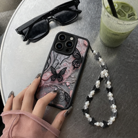KASED Midnight Wings iPhone case – black butterfly print, shown on iPhone
