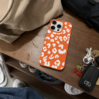 KASED Sunset Safari iPhone case – sunset-orange leopard print, close-up detail